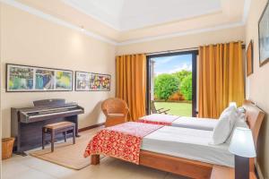a bedroom with a bed and a desk and a window at Villa Arcana - Exclusive stay in Mauritius by Sealodge in Tamarin