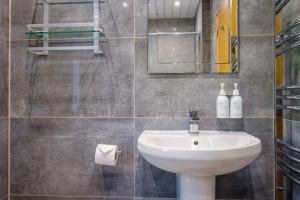 a bathroom with a sink and a mirror at The Bolt Hole in Silverdale +38 photos