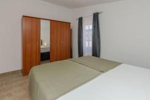 Łóżko lub łóżka w pokoju w obiekcie Apartments Tukara