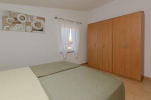 Łóżko lub łóżka w pokoju w obiekcie Apartments Tukara