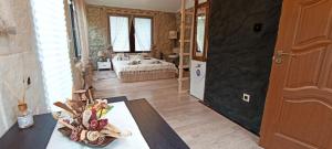 a room with a bed and a table in a room at Forest Hide Tiny House in Covasna