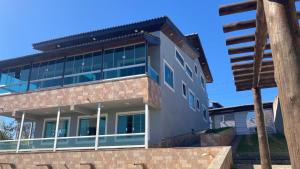 a building with glass windows and a pole at Casa em Aparecida in Aparecida