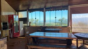 a dining room with tables and large windows at Casa em Aparecida in Aparecida