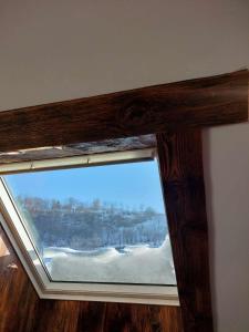 a window with a wooden frame in a room at Appartement neuf Le Grenier d'Oscar in La Bresse +13 photos