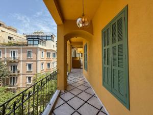 a balcony with a green door and some buildings at Hotel Lost Ashrafieh in Beirut