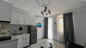 a kitchen with white cabinets and a counter top at N2 House in Chakvi