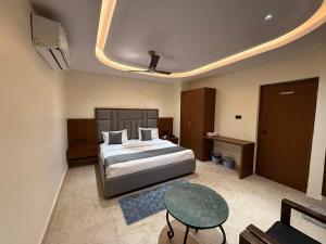 a hotel room with a bed and a table at Agarwal's Residency in Visakhapatnam