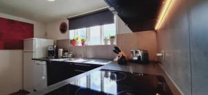 a kitchen with a black and white counter top at megiiceland in Njarðvík
