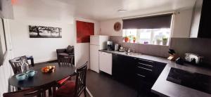 a kitchen with a table and a dining room at megiiceland in Njarðvík