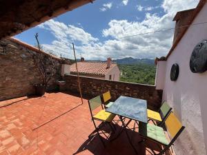 a table and chairs on a patio with a view at Wood Lodge - Sleeps10 - Skiing - Thermal Baths in Los Masos