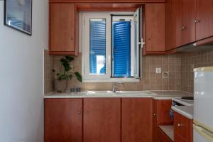 a kitchen with a sink and a window at Almira Studios in Kionia +41 photos