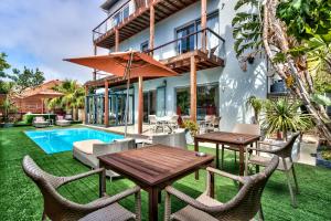a patio with a table and chairs and a pool at The One 8 Hotel in Green Point - Solar Power in Cape Town +81 photos