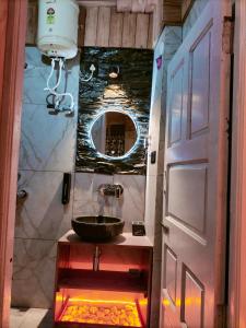 a bathroom with a sink and a door at RATAN HOMES Sunrise Valley in Jāmb