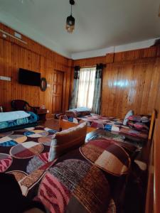 a room with a bunch of beds in it at Miryok Homes in Mirik