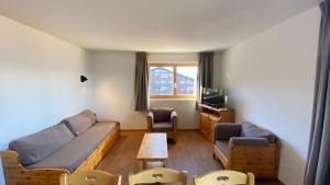 a living room with a couch and a tv at Pracondu 1 401 - OUTDOOR & FUN apartment 8 pers in Nendaz