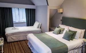 a hotel room with two beds and a window at The Casa Hotel, Sure Hotel Collection by Best Western in Yateley +80 photos