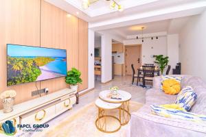 a living room with a large flat screen tv at Leshwa House A703 in Nairobi