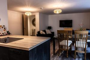 a living room with a kitchen and a living room with a table at Amazing 2BR Apt Sofa Bed in Exmouth