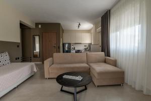 a living room with a couch and a table at Likehome Apartments in Orestiada