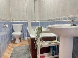 a bathroom with a sink and a toilet at Spacious Family Friendly 4-Bed Holiday Home in Ilford