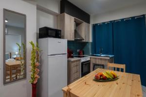 a kitchen with a table with a plate of fruit on it at Pomegranate Apartments in Kalamata