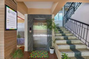 an elevator in a building with stairs and plants at Treebo Urban Oasis Inn, Sixmile in Guwahati