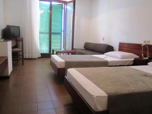 Postel nebo postele na pokoji v ubytování Hotel Zenit Neum