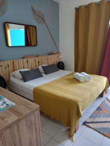 a bedroom with two beds and a mirror on the wall at studio 105 hamaca grand bourg marie galante in Grand-Bourg