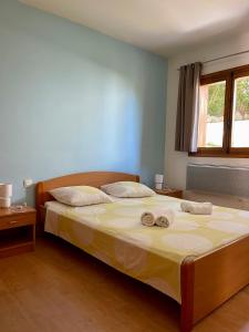 a bedroom with a bed with two towels on it at Apartment Blue Bay in Malinska +13 photos