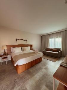 a large bedroom with a large bed and a couch at Dolphin Hotel in Fernando de Noronha +37 photos