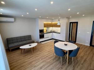 a living room with two tables and a couch at Glavinitsa Luxury Suites, Главиница in Glavinitsa