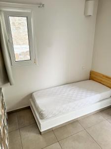 A bed or beds in a room at Filoxenia Apartments