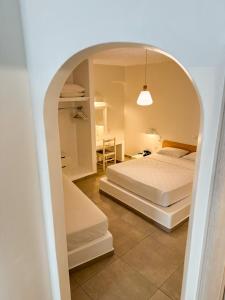 A bed or beds in a room at Filoxenia Apartments