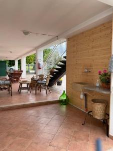 a patio with chairs and tables and a staircase at La casa di Michela in Torino di Sangro