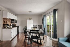 a kitchen and dining room with a table and chairs at Secret Gardens Fireplace Deck & Dog-Friendly in Inwood +43 photos