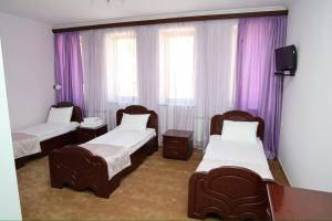 Postel nebo postele na pokoji v ubytování Syuniq Hotel