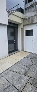 a building with two garage doors on the side of it at Ferienwohnung Bergweg in Termen +1 photo