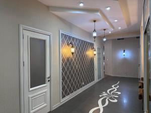 a hallway with a door and a wall with a mirror at Saphire apartment by Bakuapart in Baku +25 photos