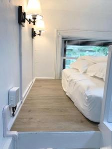 a bedroom with a white bed and a window at Private room with Shared bath on Union Square 11 in New York