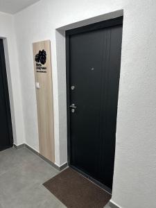 a black door with a sign on it in a hallway at Mila apartman Banja Koviljaca in Banja Koviljača