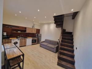 a living room with a staircase leading to a kitchen at Dimore d'Oltremare - Appartamento Levante in Lavagna
