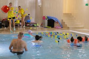 a group of people playing in a swimming pool at Prawdzic Family Resort & Wellness in Gdańsk