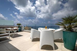 a patio with a table and chairs on a balcony at Olymp Luxury Family House in Paphos
