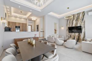 a living room with a table and chairs at Olymp Luxury Family House in Paphos