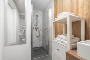 a bathroom with a shower and a sink at Apartamenty JANTARIS Prestige by BALTIC CLUB in Mielno +86 photos