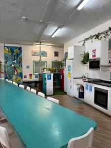 a conference room with a long table and chairs at Medano Nest Hostel in El Médano
