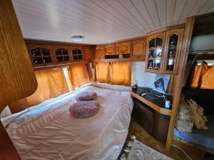 a small bed in the back of an rv at Pirates Queen Caravan in Topola