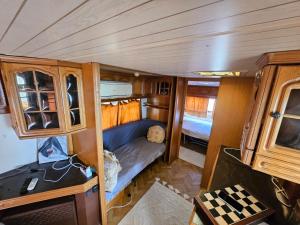 a small room with a couch in the back of an rv at Pirates Queen Caravan in Topola