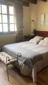 A bed or beds in a room at La Posada de Barro