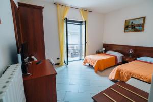 Ένα ή περισσότερα κρεβάτια σε δωμάτιο στο Albergo Settebello